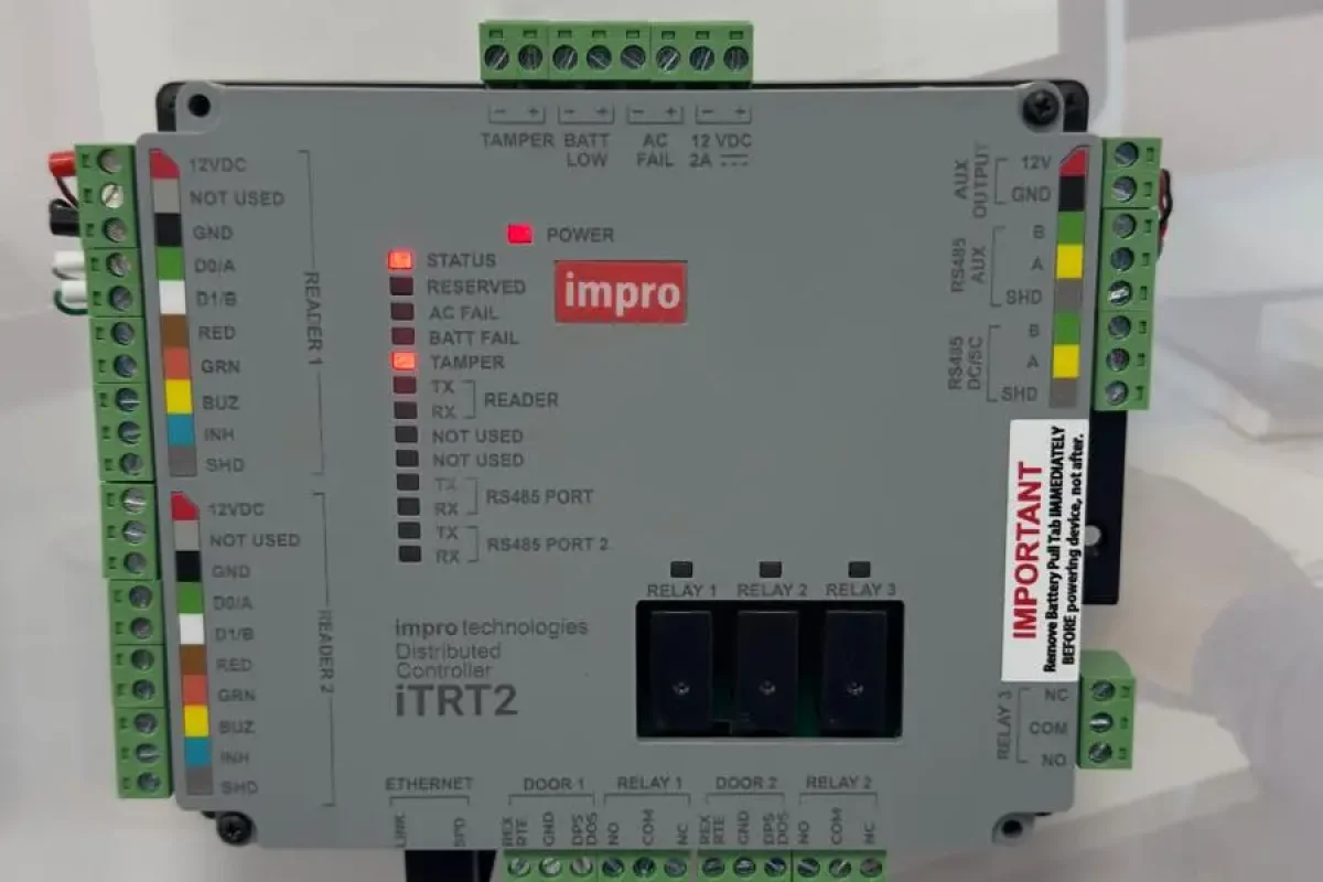 Engineer installing or servicing an access control system on a commercial building door