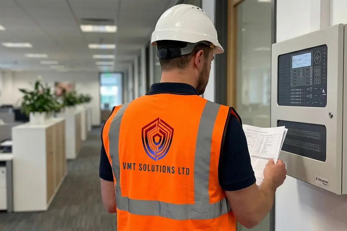 Professional fire alarm maintenance inspection on a commercial site