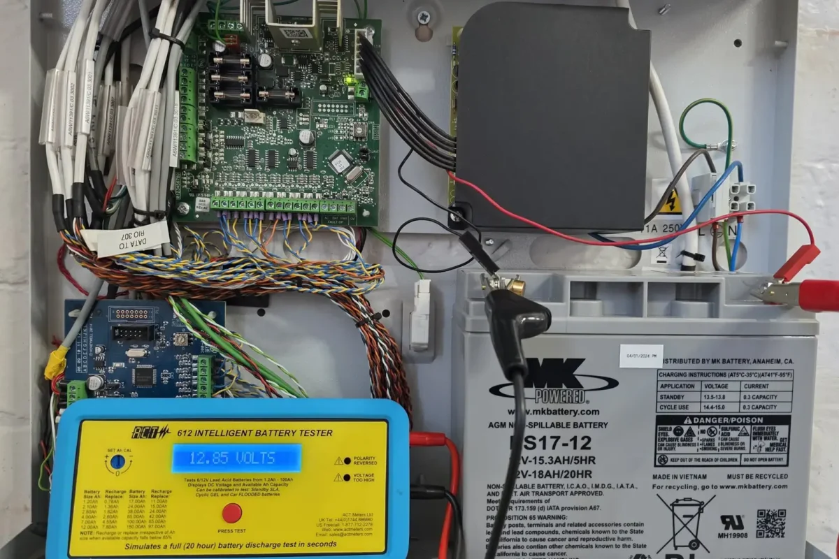 Engineer carrying out intruder alarm system maintenance and diagnostics